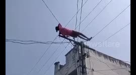 India: Drunk man climbs electric pole, lies on wires in Andhra Pradesh