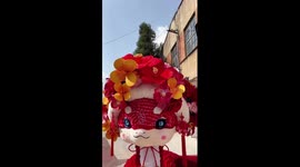 Artists in China's Yunnan adorn snake doll with hairpin flowers