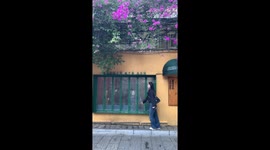 Tourist slips while posing for pictures in front of idyllic shop