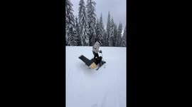 Couple Sit And Ski Down Slope