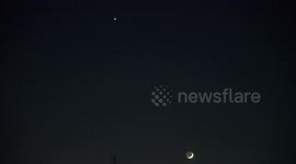 The Crescent Moon rises high in the sky over East London with Venus creating a beautiful celestial sight.