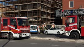 Two parked fire trucks as a group of firefighters wait during an intervention on New Year's Day in Rome.