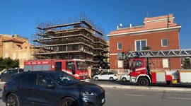 Two parked fire trucks as a group of firefighters wait during an intervention on New Year's Day in Rome.