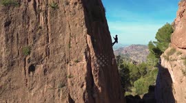 Man rock climbing aerial view of sportsman rapelling mountain in La Panocha, el Valle Murcia, Spain woman rapel down a mountain climbing a big rock