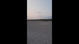 Beautiful sunset at Hiratsuka Beach near Tokyo with a few people.