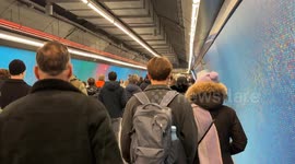 People walk in the tunnel of the Piazza di Spagna metro stop in winter in Rome.