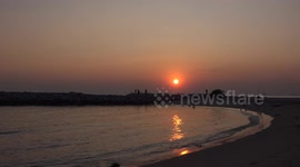 People enjoying a beautiful sunset on a beach in Rayong Thailand, a wonderful way to start 2025.