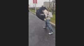 Girl battles strong winds through typhoon wind in China