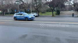 The passage of a police car on a street in Rome.