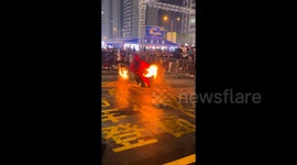 Unaware crowd watches on as performer's fire stunt goes wrong, burning his leg