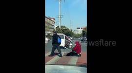Elderly man pulls wife across street on child's wiggle car