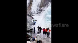 Huge icicle falls from frozen waterfall onto fleeing tourists below in China