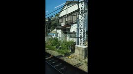 Train ride view from Tokyo to Yokohama on a spring morning. Traditional Japanese Houses.
