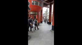 Entrance to Asakusa temple in Tokyo, bustling with tourists, filmed in spring.