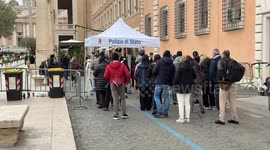 Carabinieri and police officers in Via della Conciliazione carry out preliminary checks on people heading towards St. Peter's Square on Epiphany Day in Rome.