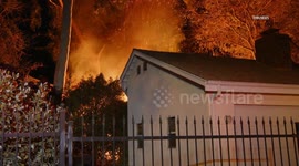 US, Los Angeles: North Hollywood Large Fire Burns Behind Home