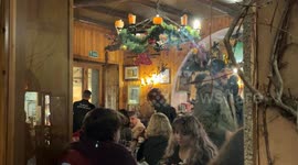 Customers inside a Trastevere restaurant seen from outside the window during the Christmas period in Rome.