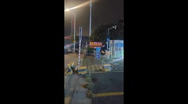 Chinese man attempts to lift heavy road barrier like a barbell