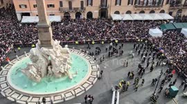 Witch on flying broomstick hoisted above Piazza Navona in Rome