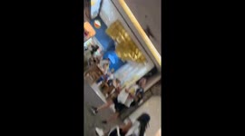 Tourists fight over seats in departure hall at Thai airport