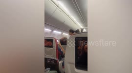 Plane passenger arrested for refusing to wear seatbelt sparking angry scenes on plane