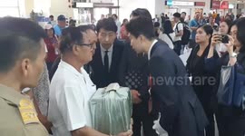 Remains of South Korea plane crash victim arrive back in Thailand in a silk-covered box