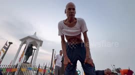 Yogi retrieving rope from nose and pulling it out through mouth, leaving onlookers stunned in India