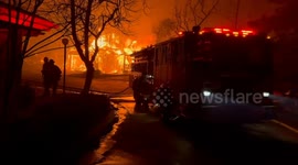 Firefighters battle flames as blaze rips through Los Angeles community