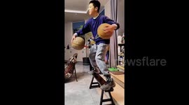 Young boy dazzles with impressive basketball skills involving 2 balls