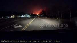 Dashcam footage shows Pacific Palisades wildfire burning at night