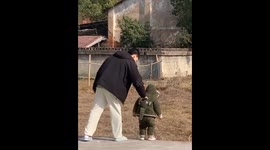 Playful guardian: Uncle prevents nephew's leap in heartwarming village scene