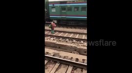 Woman knocked over by train curls up in a ball until danger passes