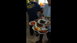 1- Indonesian restaurant worker balances seventeen plates on one arm