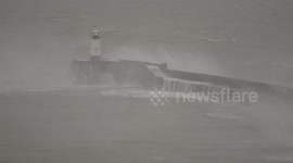 Windy start to 2025 at Newhaven's Lighthouse on East Sussex Channel Coast UK as gale force South Westerly's whip up the waves.