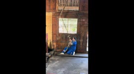 Traditional oil-pressing hammer in action in Guizhou, China