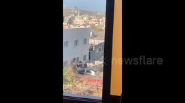 West Bank: Israeli soldiers detain a Palestinian after besieging a house in the town of Qabatiya, north of the West Bank