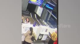 Elderly passenger mistakes airport check-in desk belt for escalator and disappears into baggage area