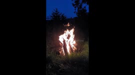 A campfire at night in nature, relaxing by the campfire outdoors.
