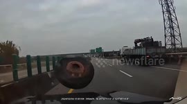 Truck's tyre comes off and flies into cars leaving them damaged