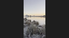 Sunrise by a frosty river
