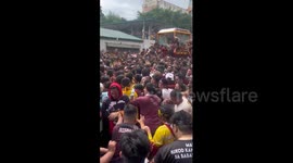 Filipino Catholics swarm Black Nazarene's carriage during procession in Manila