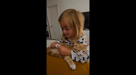 Little girl crying over cute kitten.