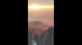 Sunlit snow-dusted mountain in China's Chongqing