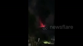 Worried residents watch Mount Ibu volcano eruption in Indonesia