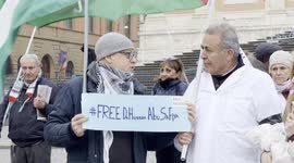 Israel-Hamas War: A protester holds a sign with the slogan ‘Free Dr. Hussam Abu Safiya’ while talking to Yousef Salman, head of the Palestinian community in Rome and Lazio, during the demonstration of solidarity with Dr. Hussam Abu Safiya of the health do