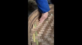 Elderly craftsman repairs bamboo steamer in China