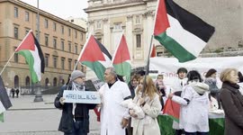 Israel-Hamas War: A protester holds a sign with the slogan ‘Free Dr. Hussam Abu Safiya’ while talking to Yousef Salman(c), head of the Palestinian community in Rome and Lazio, while waving Palestinian flags, during the demonstration of solidarity with Dr.