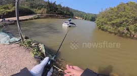 Fisherman uses strong line to reel in SUV floating in pond and rescue driver perched on roof