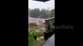 Bridge collapses as floods surge through villages in Indonesia