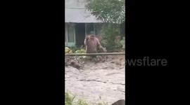 Flash floods surge through homes as residents battle to save animals
